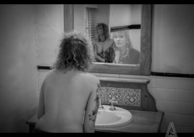 A woman studies herself while another version waits in the reflection. My Thoughts: Identity is not discovered. It is continually created. Muse: FERNE