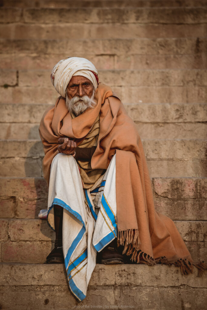 A seated man on stone steps, Varanasi, India — Glenn Alderson