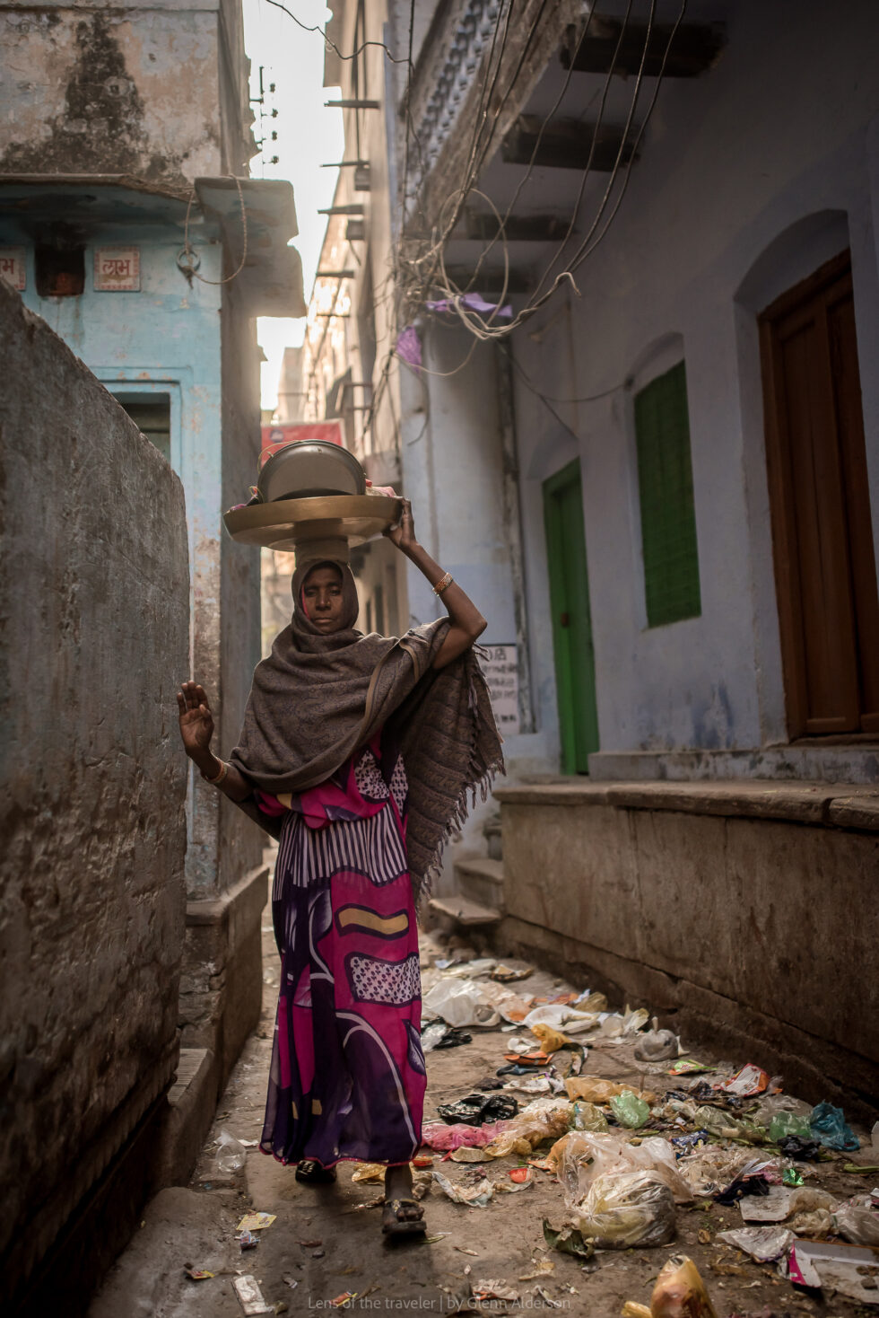A person carrying a basket in a narrow lane, Varanasi, India — Glenn Alderson