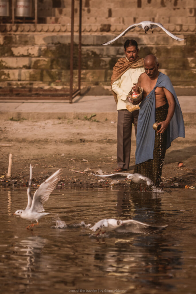 A person by the water with birds, Varanasi, India — Glenn Alderson
