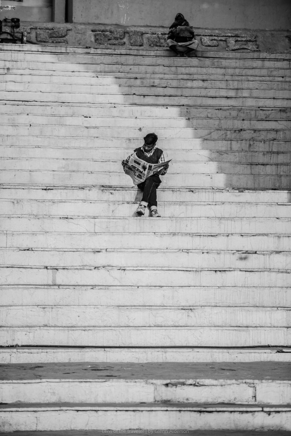 A figure seated on a broad flight of steps, Varanasi, India — Glenn Alderson
