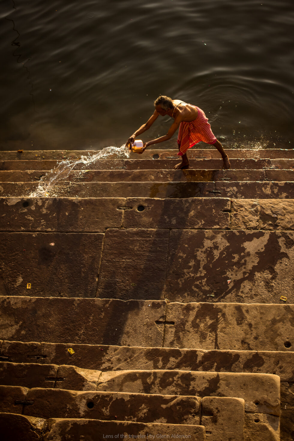 Water being poured across stone steps, Varanasi, India — Glenn Alderson