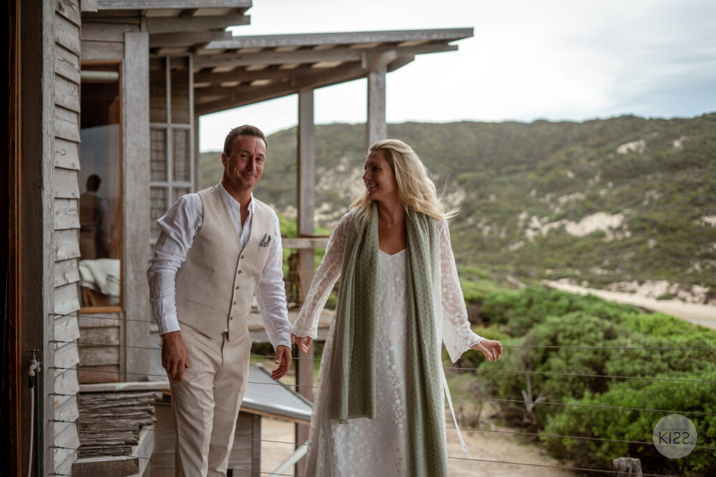 A couple walking together on a timber veranda