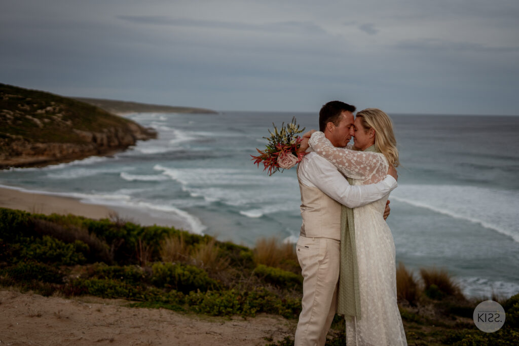 A couple embracing above the beach