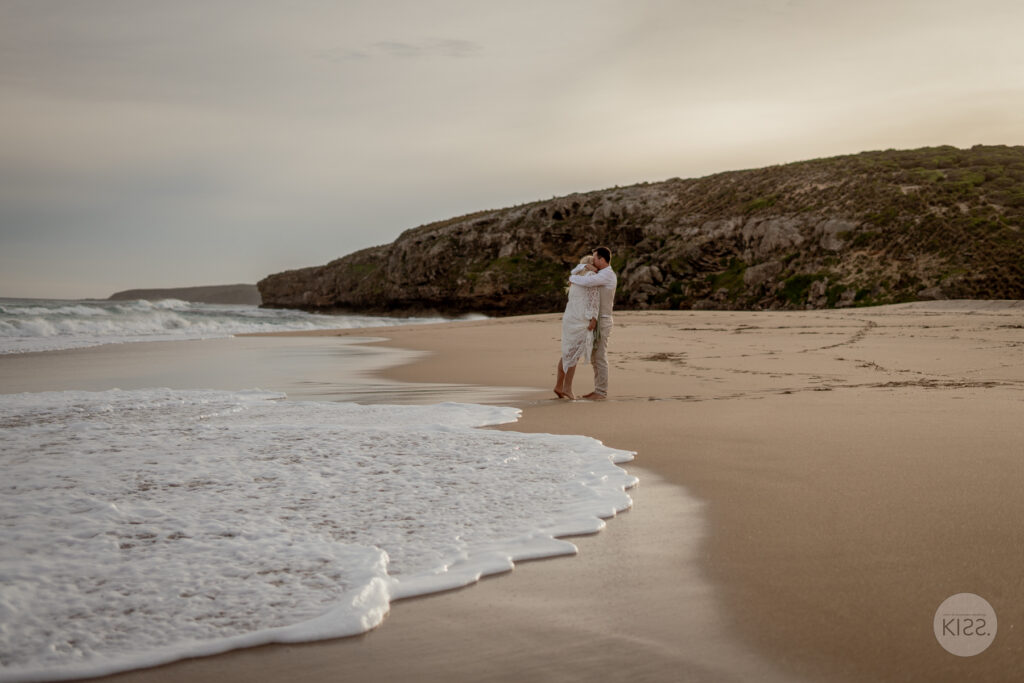 A bride standing at the edge of the sea